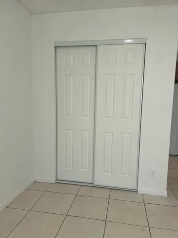 a view of an empty room and a window