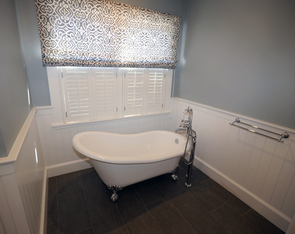 154 Main Street Andover, MA 01810 - Photo 23 of 42 a bathroom with a granite countertop sink and a mirror