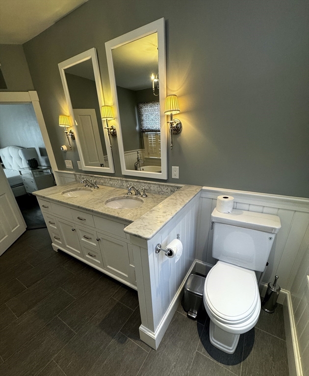 154 Main Street Andover, MA 01810 - Photo 25 of 42 a bathroom with a sink a toilet and mirror
