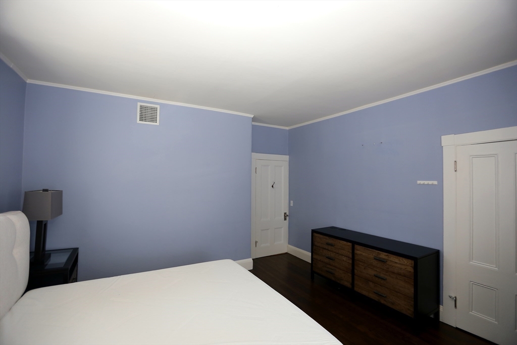 154 Main Street Andover, MA 01810 - Photo 27 of 42 a bedroom with a bed and a dresser
