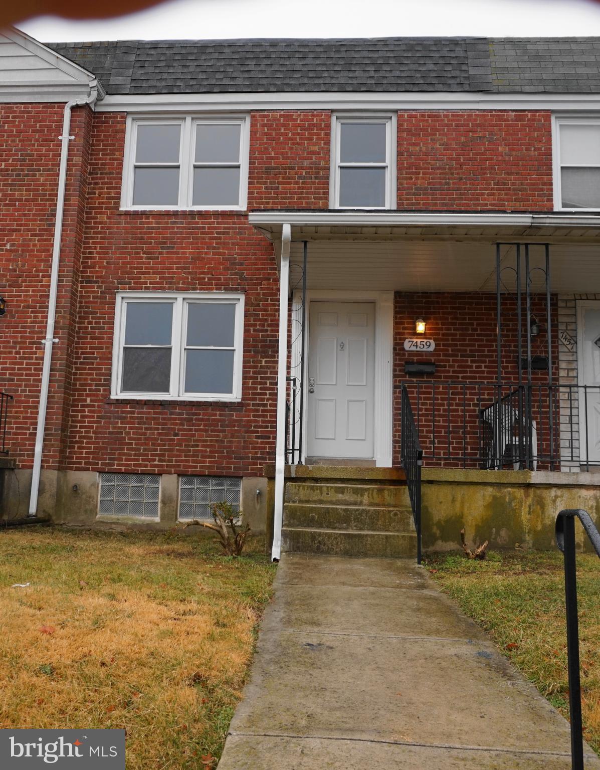 7459 School Avenue Dundalk, MD 21222 - Photo 1 of 23 a front view of a house with a yard