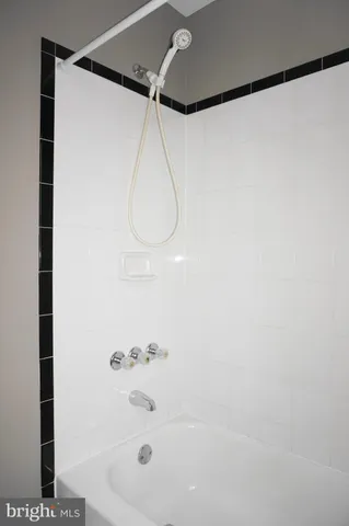 a bathroom with a shower and a glass door