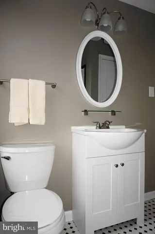 a bathroom with a sink mirror and toilet