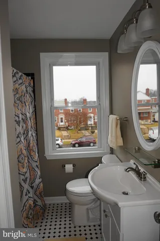a bathroom with a toilet sink and mirror