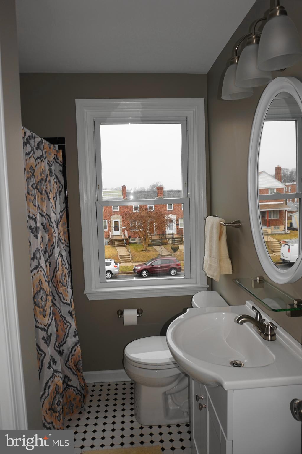 7459 School Avenue Dundalk, MD 21222 - Photo 15 of 23 a bathroom with a toilet sink and mirror