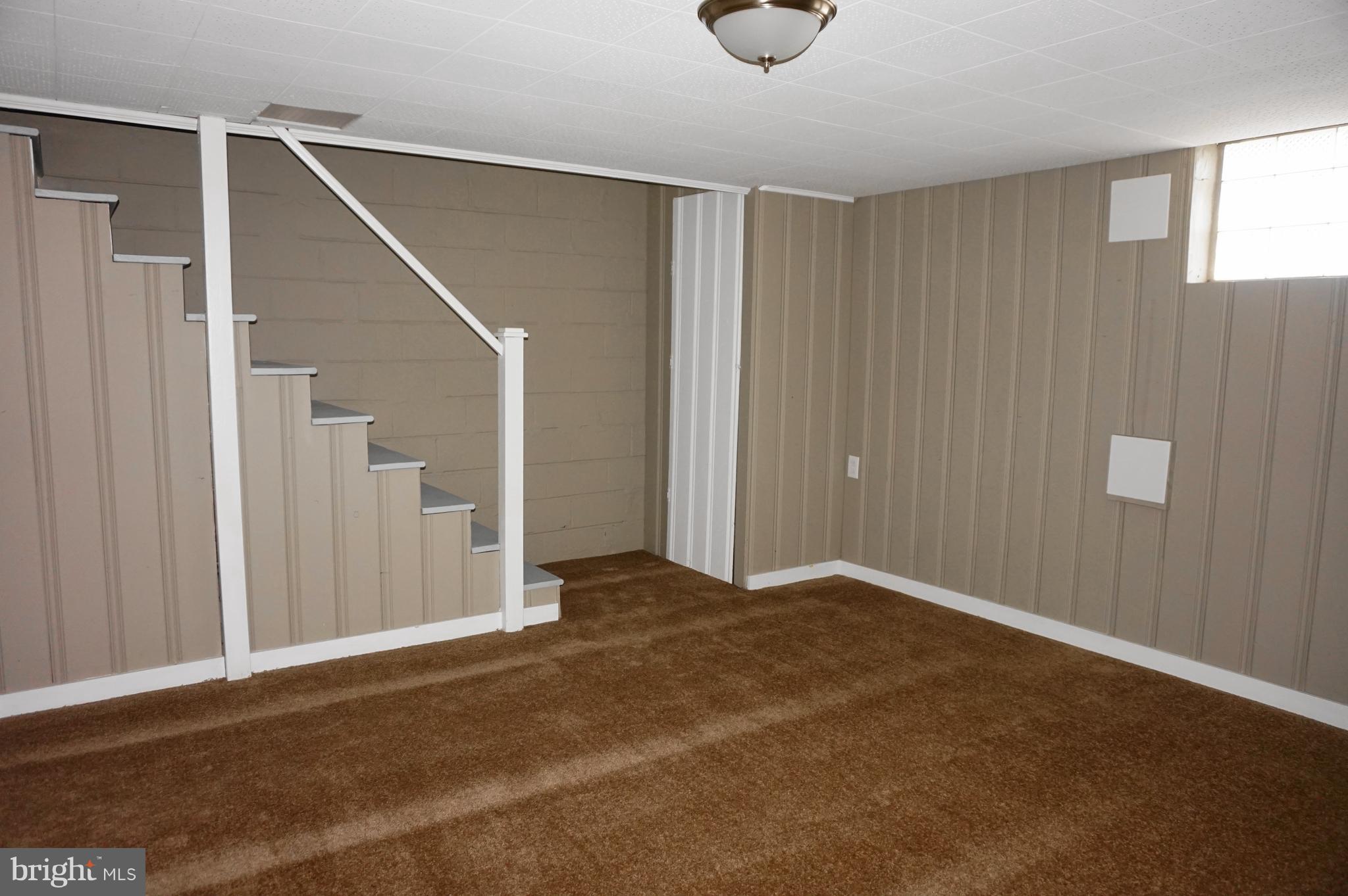 7459 School Avenue Dundalk, MD 21222 - Photo 19 of 23 a view of an empty room with wooden floor and entryway