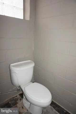 a white toilet sitting next to a white sink