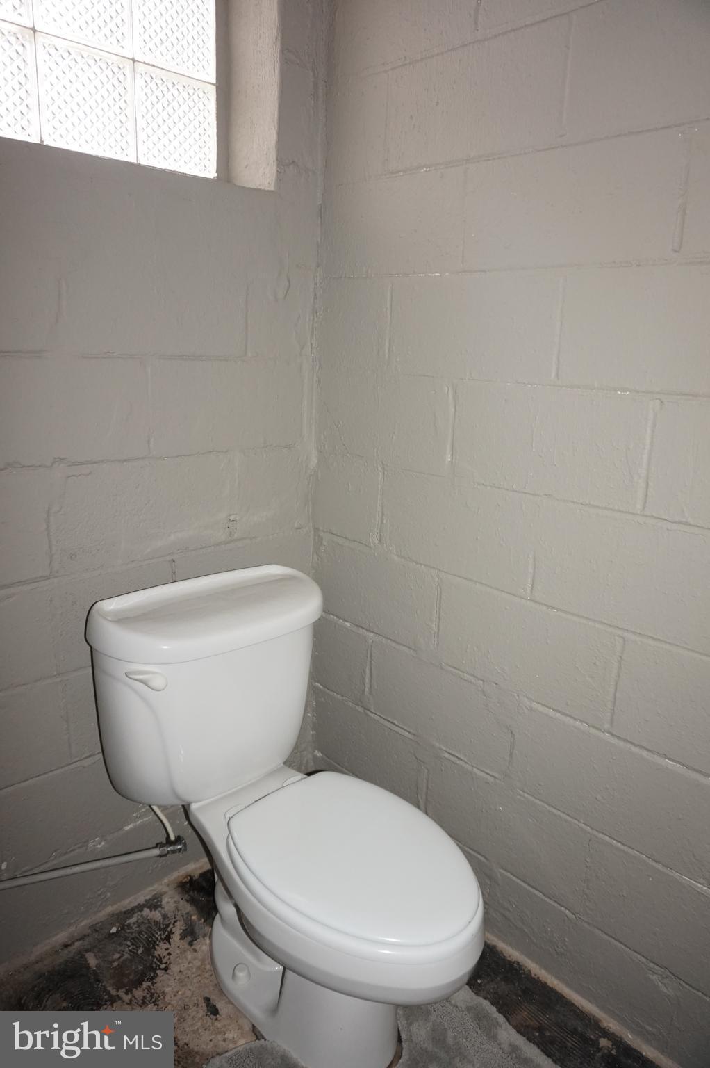 7459 School Avenue Dundalk, MD 21222 - Photo 22 of 23 a white toilet sitting next to a white sink