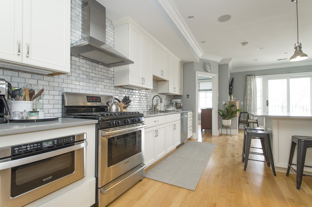 37 P Street, Unit 4 Boston, MA 02127 - Photo 2 of 13 a kitchen with a stove a sink and a microwave