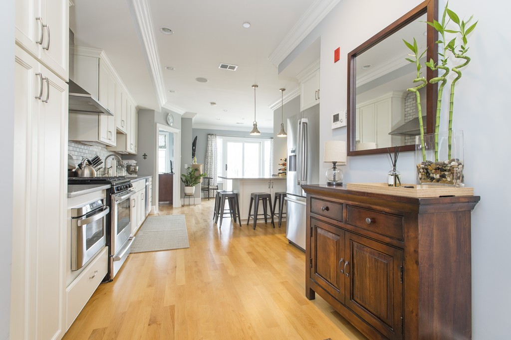 37 P Street, Unit 4 Boston, MA 02127 - Photo 3 of 13 a kitchen with stainless steel appliances granite countertop a lot of counter top space and wooden floor