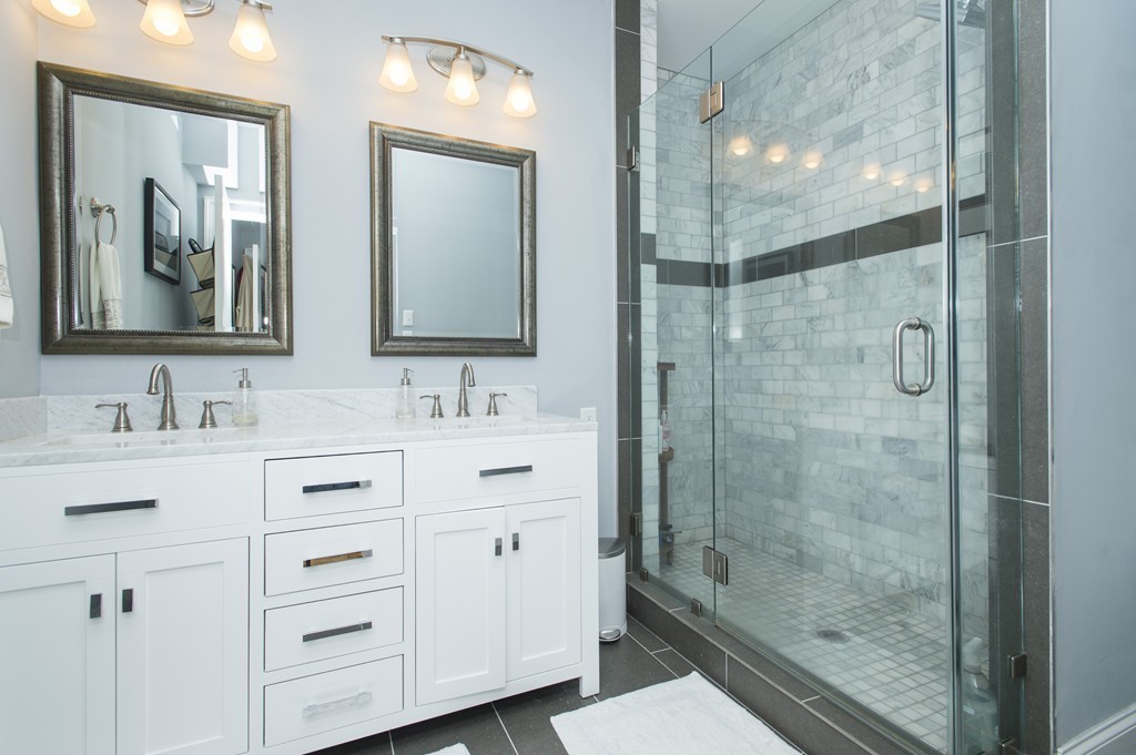 37 P Street, Unit 4 Boston, MA 02127 - Photo 8 of 13 a bathroom with a double vanity sink mirror and shower