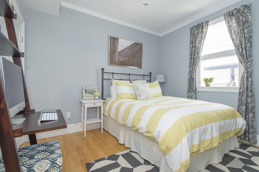 37 P Street, Unit 4 Boston, MA 02127 - Photo 9 of 13 a bedroom with a bed and wooden floor