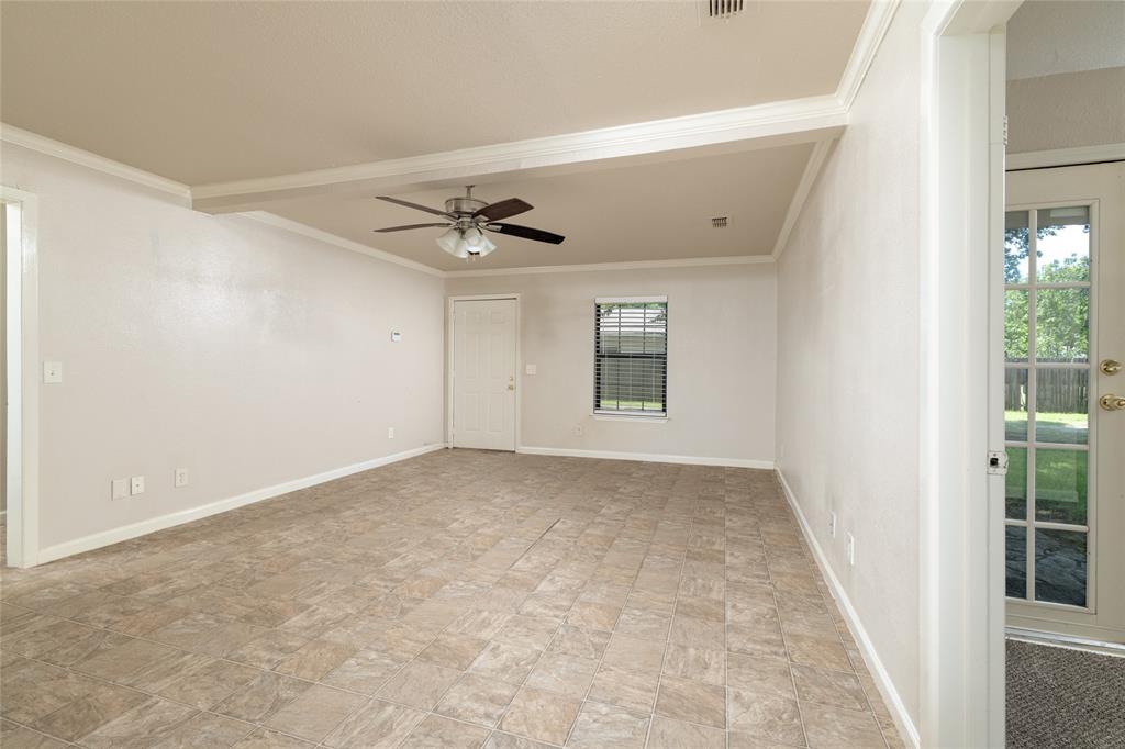 313 North Roe Street White Settlement, TX 76108 - Photo 8 of 33 Spacious room with durable tile flooring, crown molding, and a ceiling fan