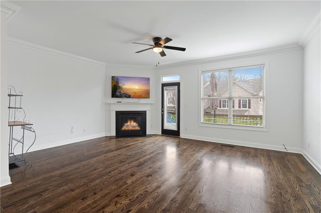 7054 Elmwood Ridge Court Atlanta, GA 30340 - Photo 12 of 44 a view of a livingroom with wooden floor a fireplace and windows