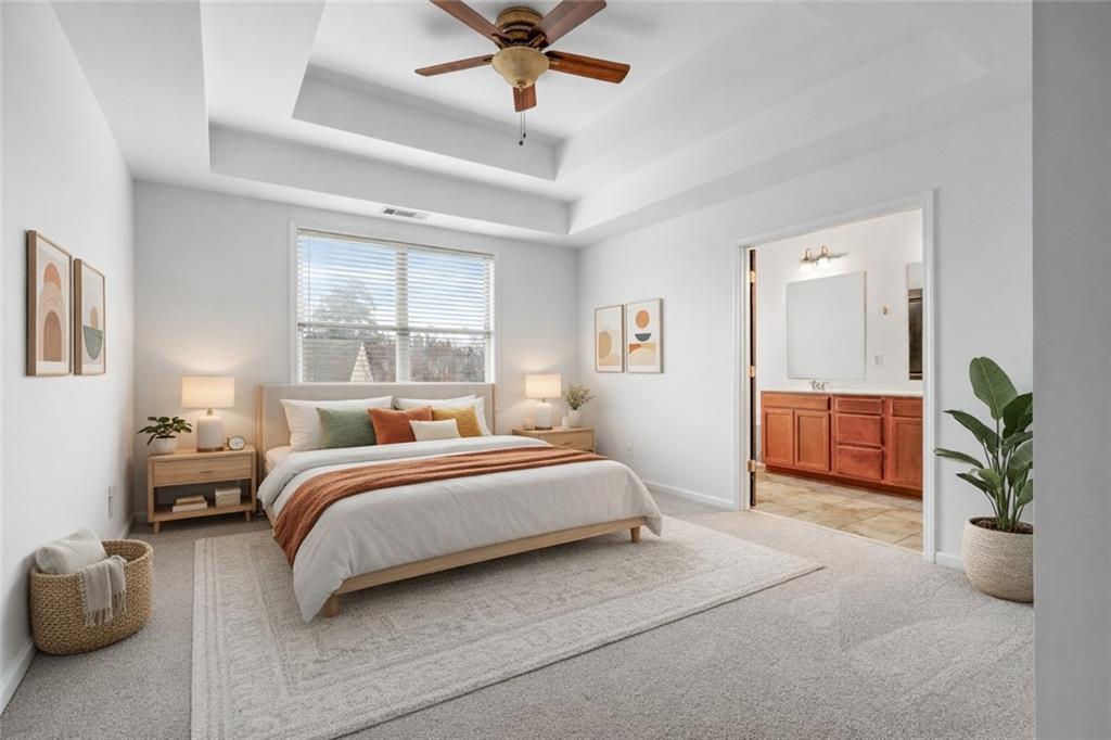 7054 Elmwood Ridge Court Atlanta, GA 30340 - Photo 16 of 44 a bedroom with furniture and a potted plant