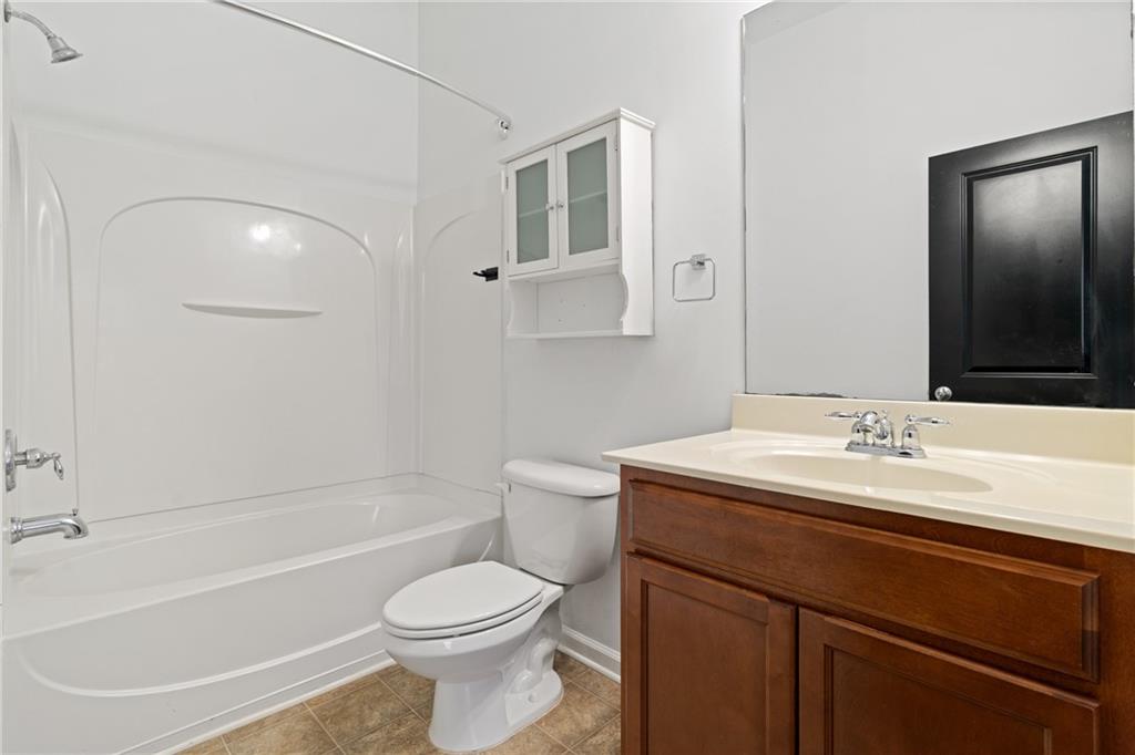 7054 Elmwood Ridge Court Atlanta, GA 30340 - Photo 25 of 44 a bathroom with a sink a toilet and shower