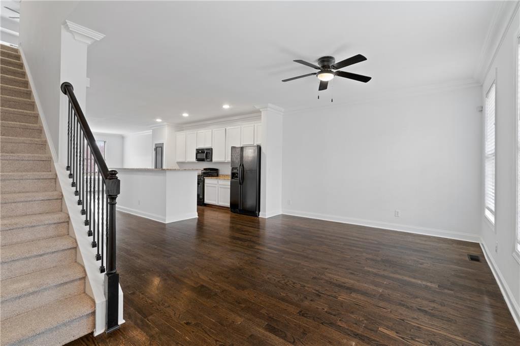 7054 Elmwood Ridge Court Atlanta, GA 30340 - Photo 3 of 44 a view of a livingroom with wooden floor and staircase