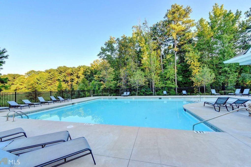 7054 Elmwood Ridge Court Atlanta, GA 30340 - Photo 31 of 44 a view of a swimming pool with chairs