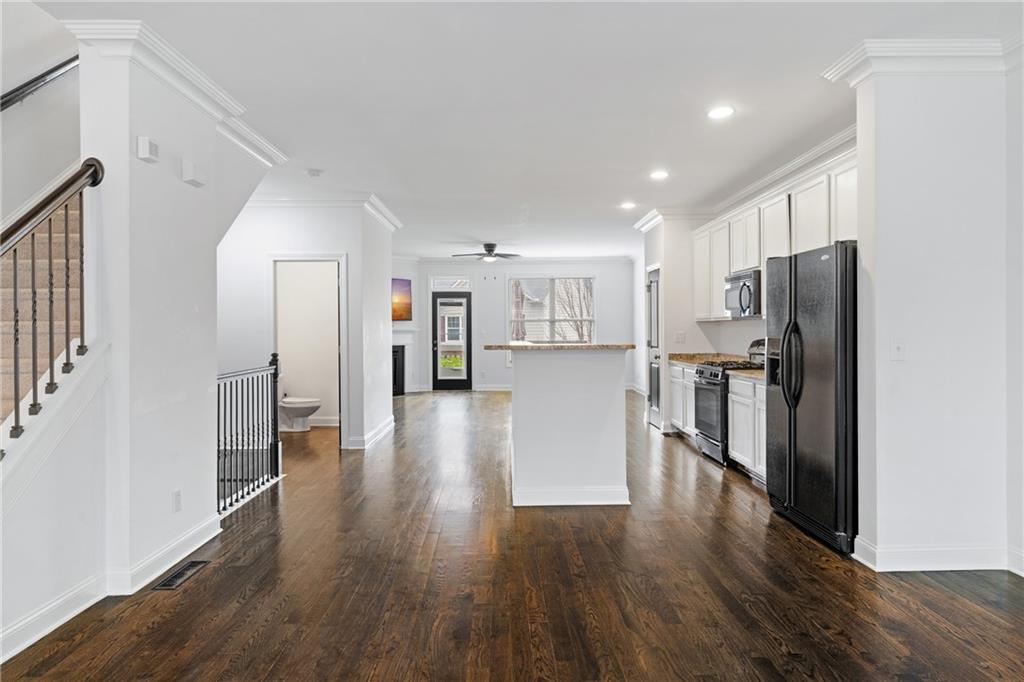 7054 Elmwood Ridge Court Atlanta, GA 30340 - Photo 6 of 44 a view of a kitchen with refrigerator and wooden floor