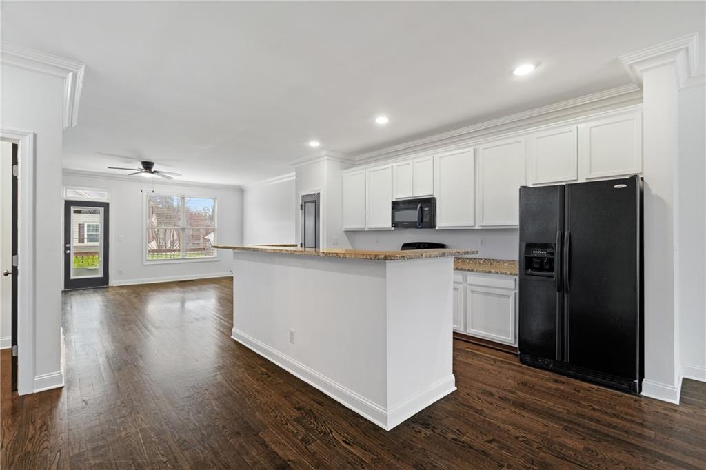 7054 Elmwood Ridge Court Atlanta, GA 30340 - Photo 7 of 44 a kitchen with refrigerator and cabinets