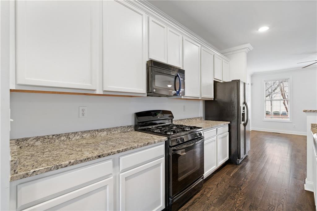 7054 Elmwood Ridge Court Atlanta, GA 30340 - Photo 9 of 44 a kitchen with stainless steel appliances granite countertop a stove a refrigerator and a microwave