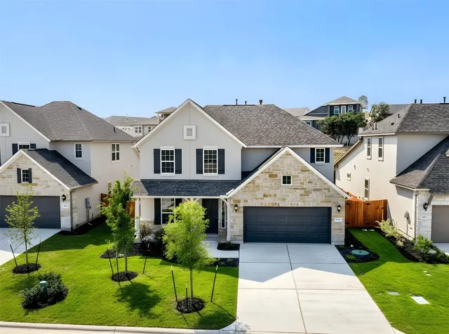 a front view of house with yard and green space