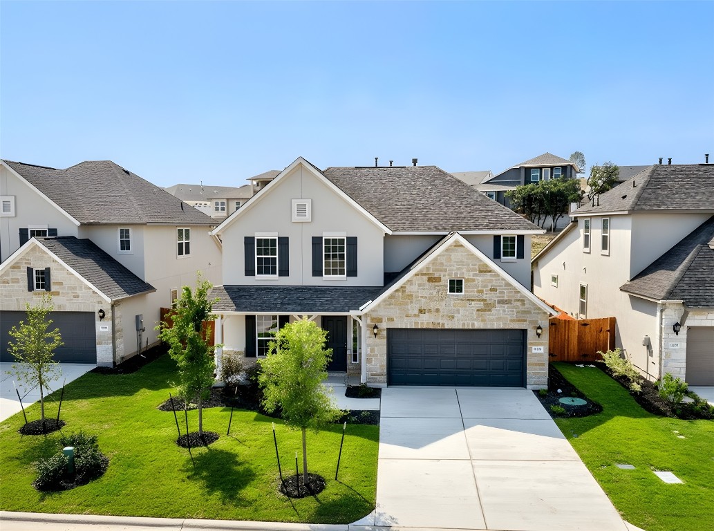 a front view of house with yard and green space