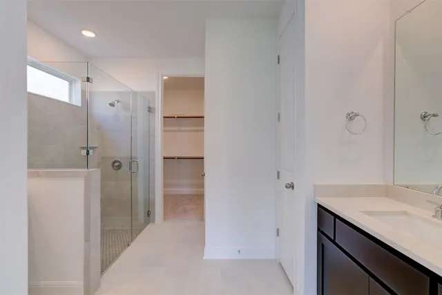 a bathroom with a granite countertop sink shower and a mirror