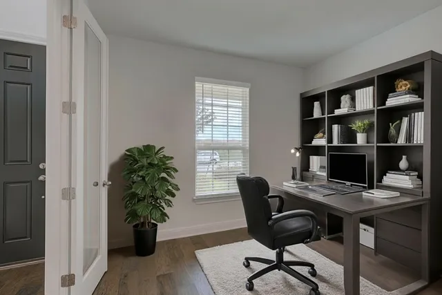 a view of a workspace with furniture and a potted plant