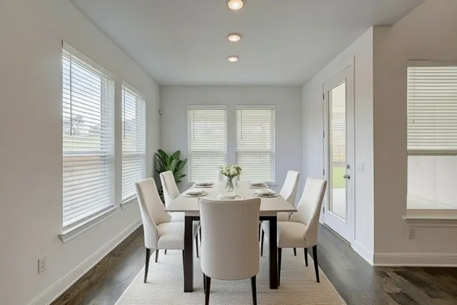 a view of a dining room with furniture and window