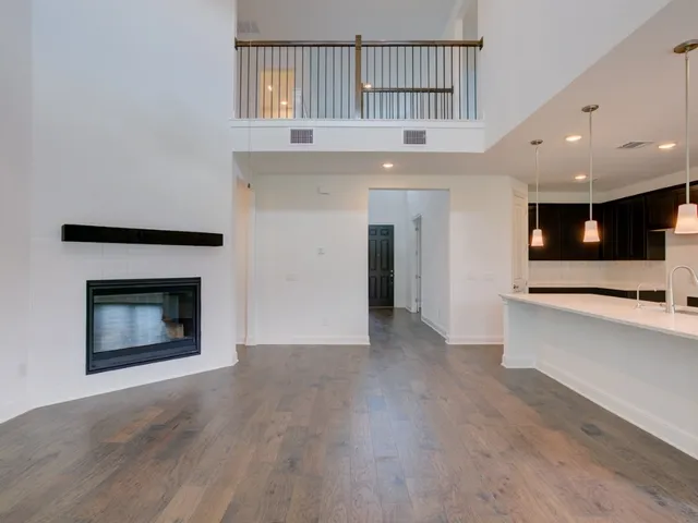 a view of an empty room with a fireplace and a window