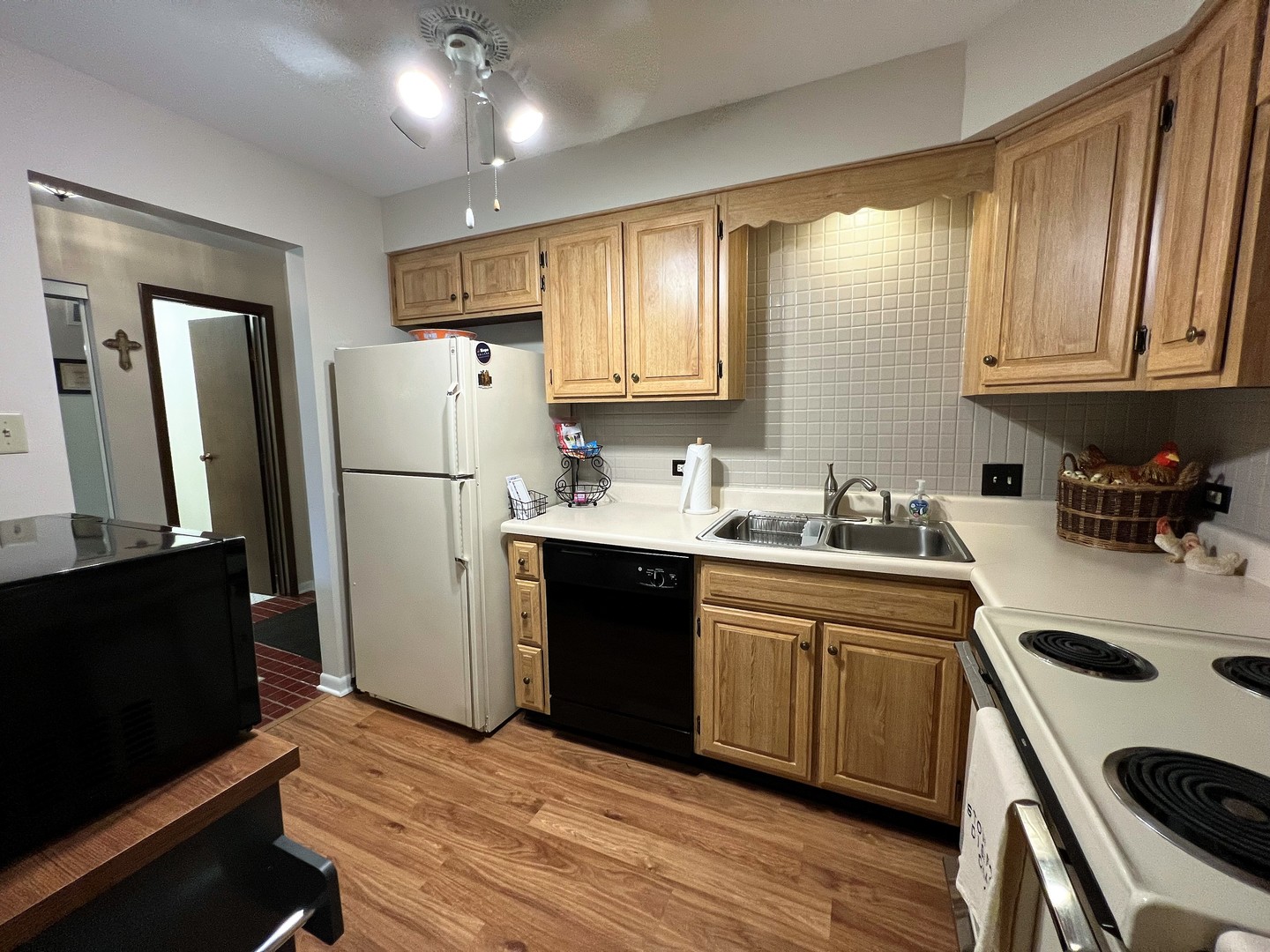 2311 183rd Street, Unit 206B Homewood, IL 60430 - Photo 7 of 26 a kitchen with a refrigerator sink and cabinets