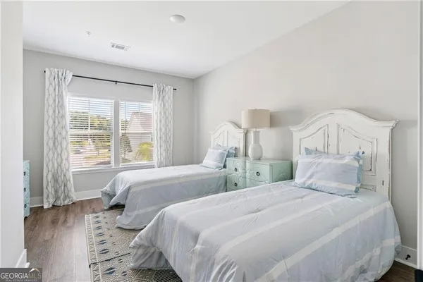 a bedroom with a large bed and a window