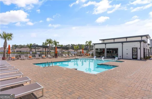 a view of a swimming pool with a lounge chairs
