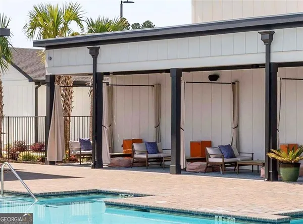 a view of living room filled with furniture and floor to ceiling window