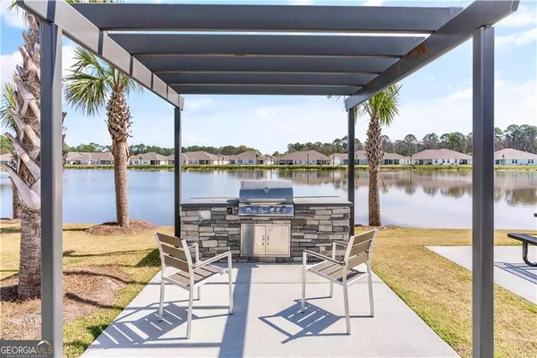 a view of a lake from a balcony with furniture