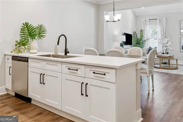 a white kitchen with sink and window