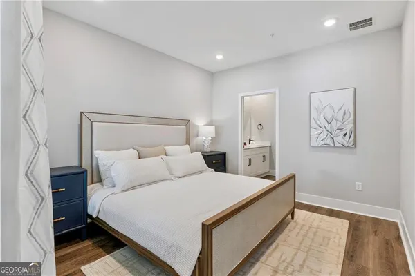 a room with a bed and a painting on the wall