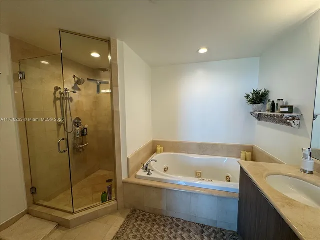 a bathroom with a bathtub and a double vanity sink