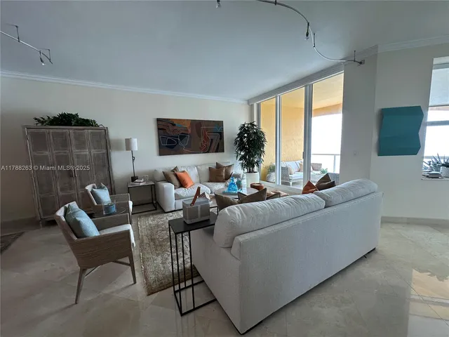 a living room with furniture and large windows