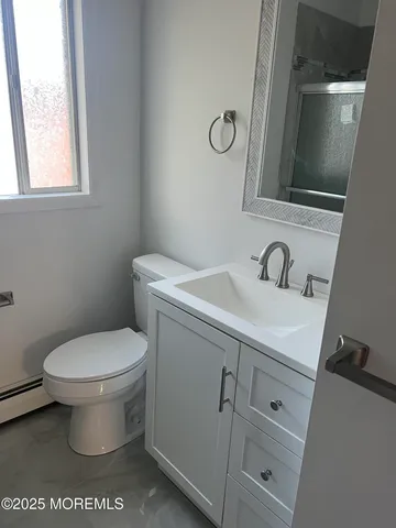 a bathroom with a sink toilet and mirror