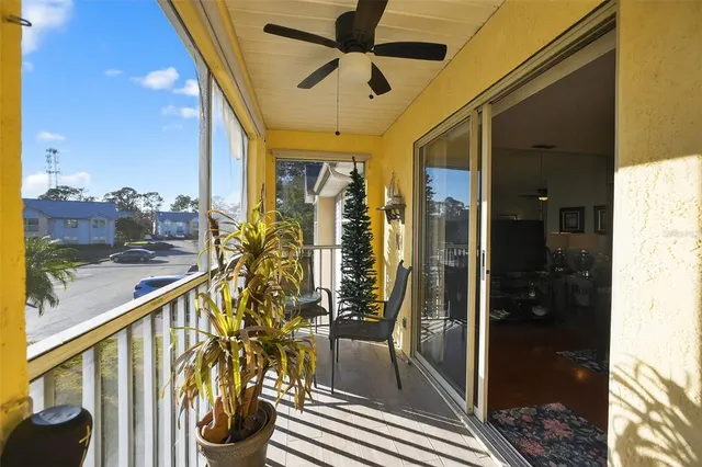 a view of a balcony with chairs and wooden floor