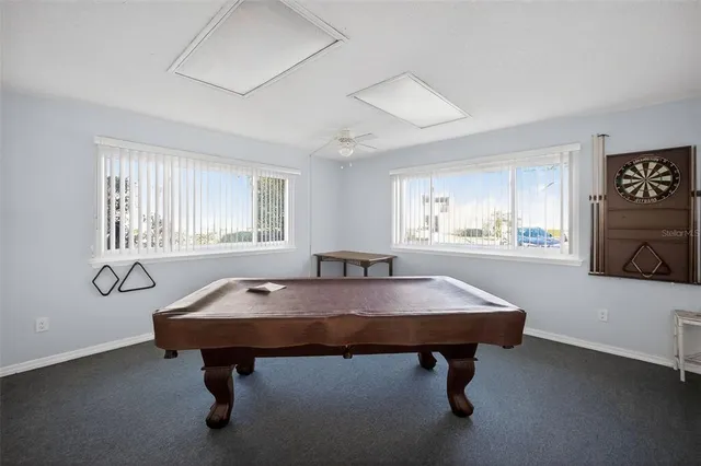 a dining room with table chairs and window