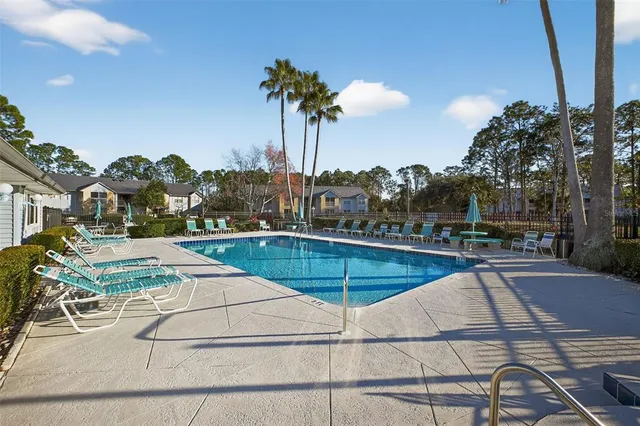 a view of a swimming pool with a table and chairs