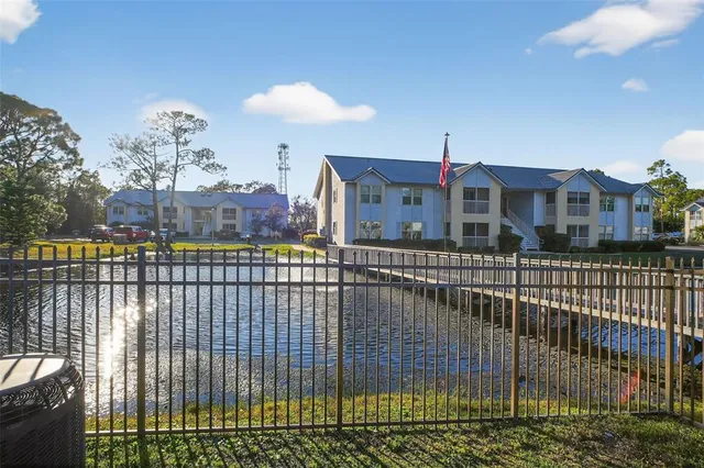 a big yard with table and chairs and a barbeque