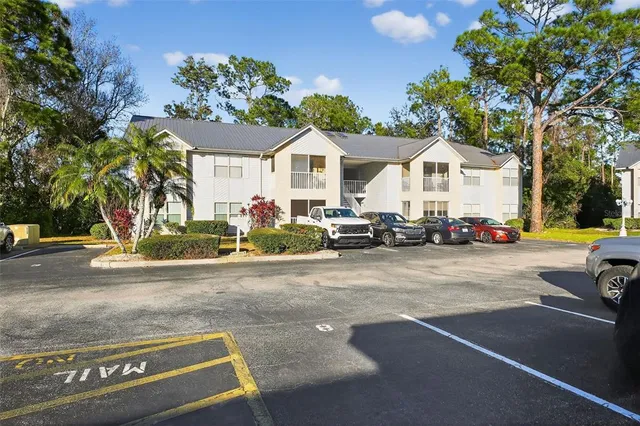 a view of sign board with buildings in the background