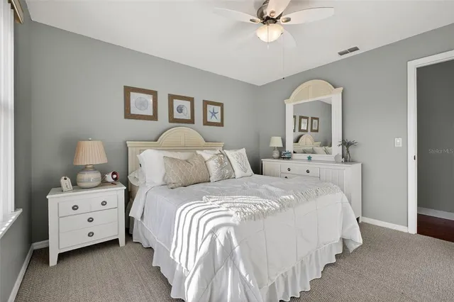 a bedroom with bed and a chandelier