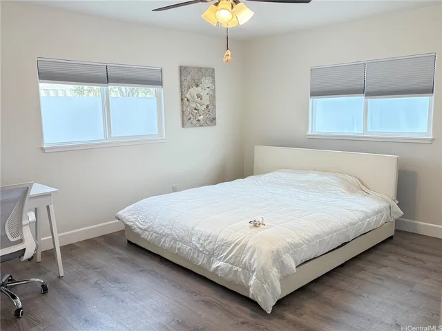 a large bed sitting in a bedroom next to a window