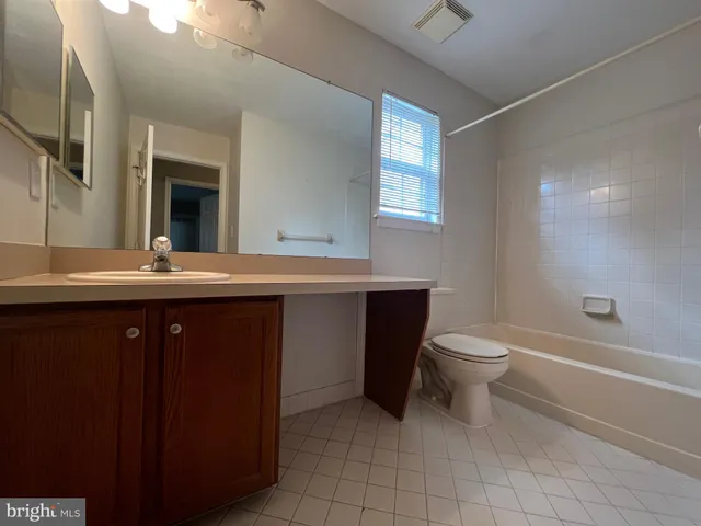 a bathroom with a sink toilet and mirror
