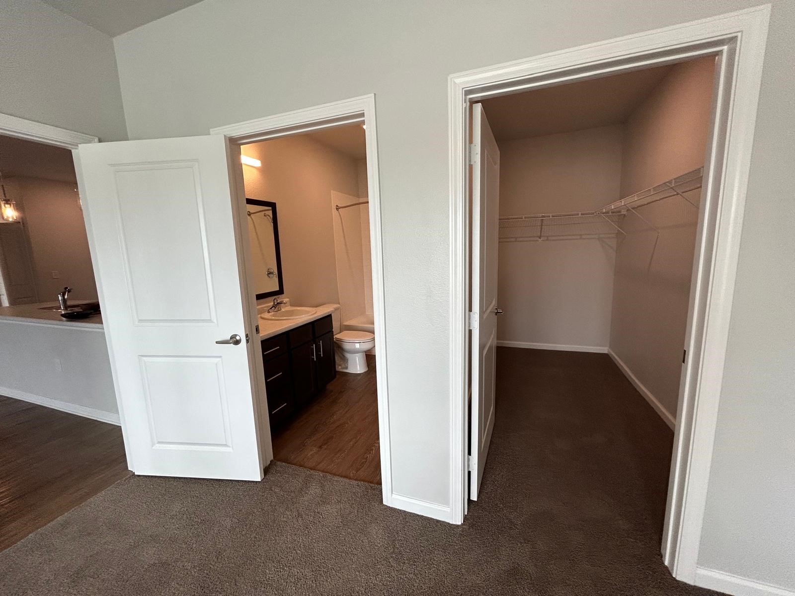 2136 West 34th Street, Unit 147 Houston, TX 77018 - Photo 6 of 11 a view of hallway with stairs and wooden floor